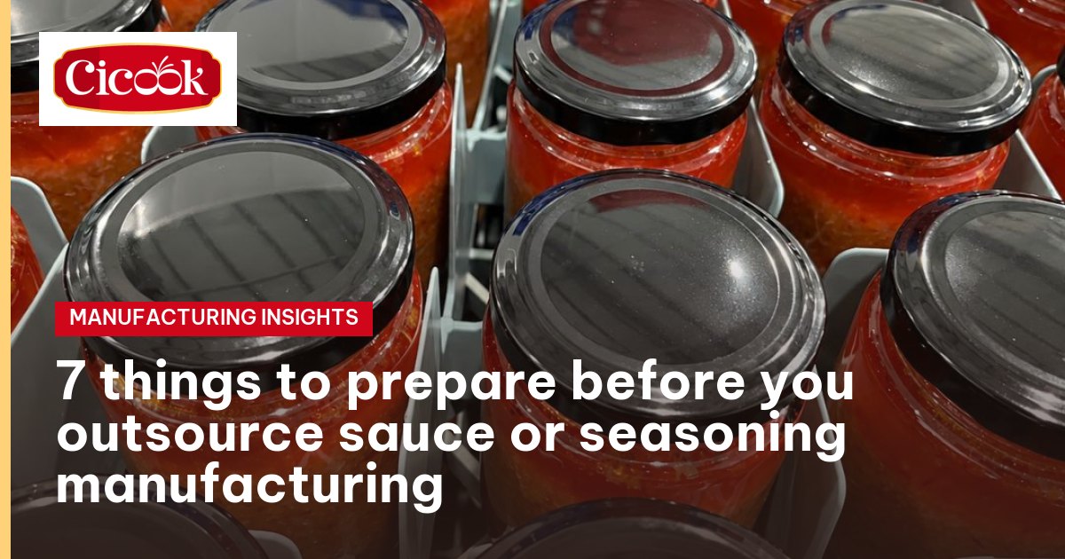 Jars of garlic-chilli sauce with tin lids on the packing line