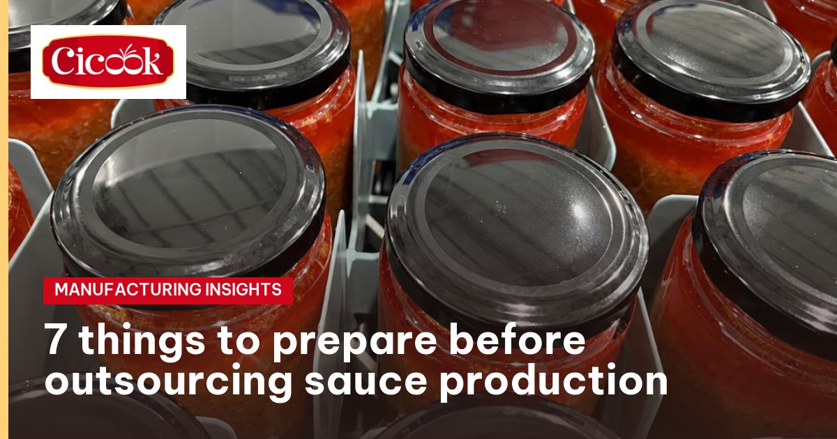 Jars of garlic-chilli sauce with tin lids on the packing line